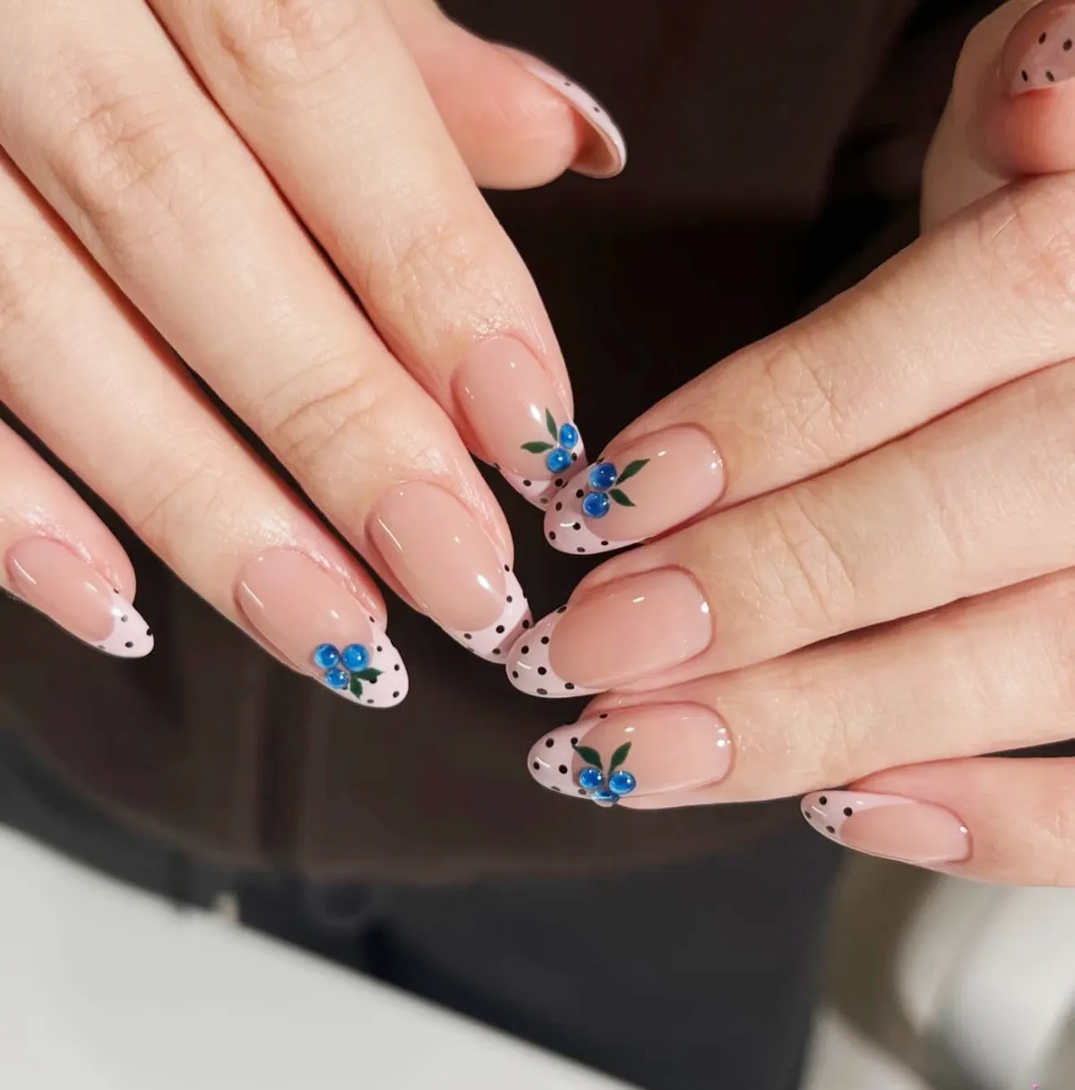 Minimal polka-dot French tips with small blue-and-green accents