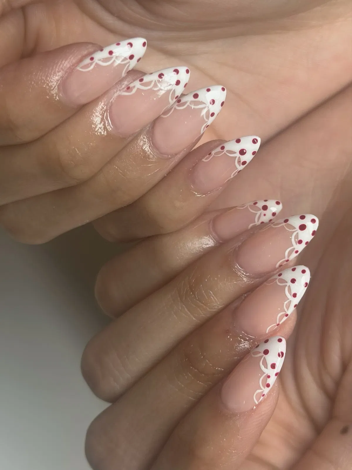 Red polka-dot French tips with white scalloped detailing