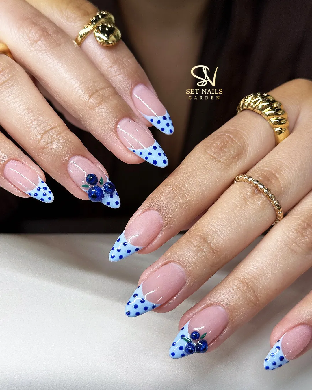 Blue polka-dot French tips with 3D berry accents