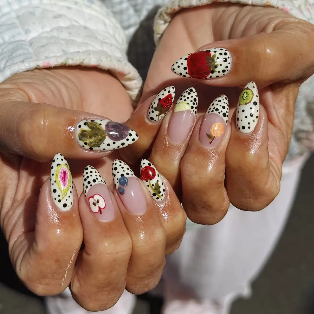 Black polka-dot French tips with fruit-style accents