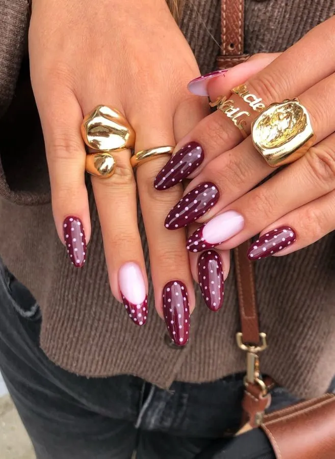 Burgundy polka dots with a pale pink accent nail