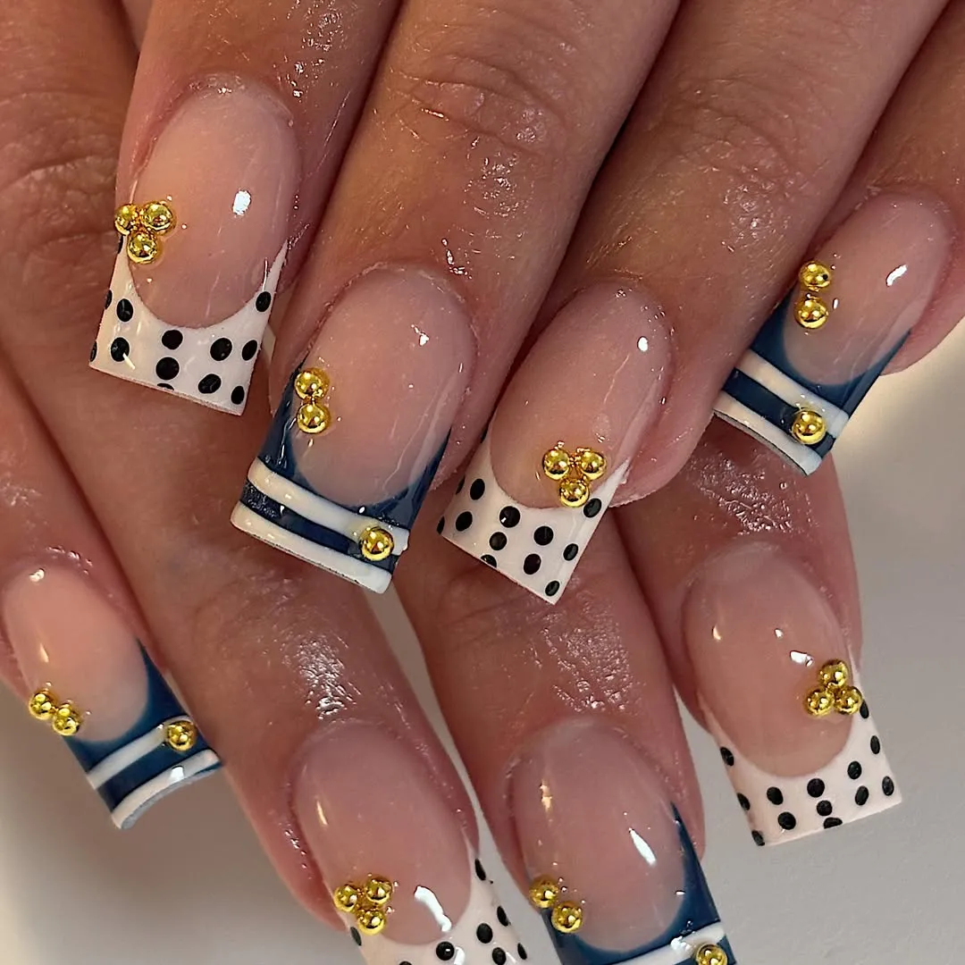 Square French tips with polka dots, stripes, and gold beads