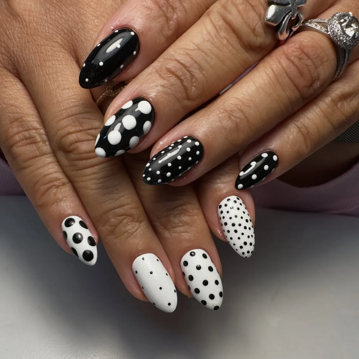 Alternating black and white bases with varied polka dot sizes