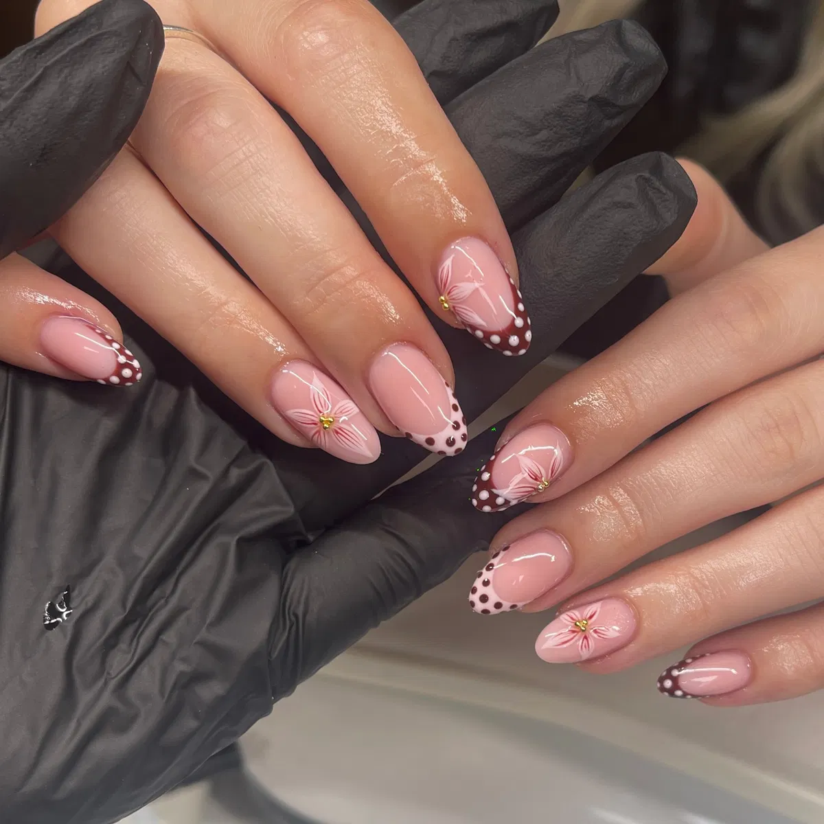 Brown dotted French tips with white petal linework