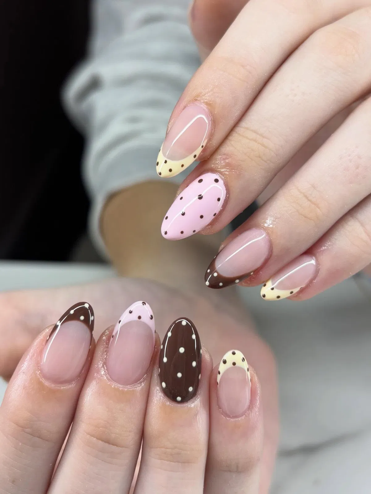 Brown polka dots across French tips and full-color accents
