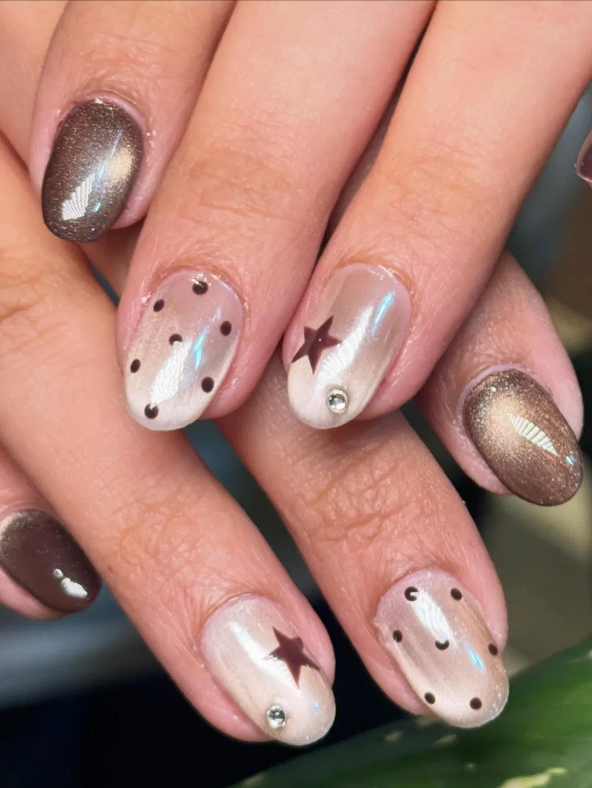 Metallic brown mix with dotted nude nails and star accents