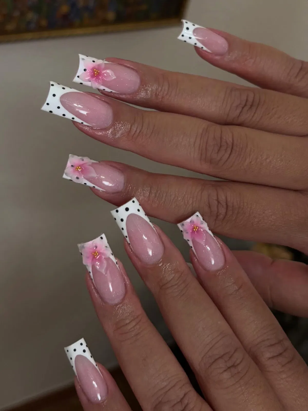 White polka-dot French tips with pink floral accents