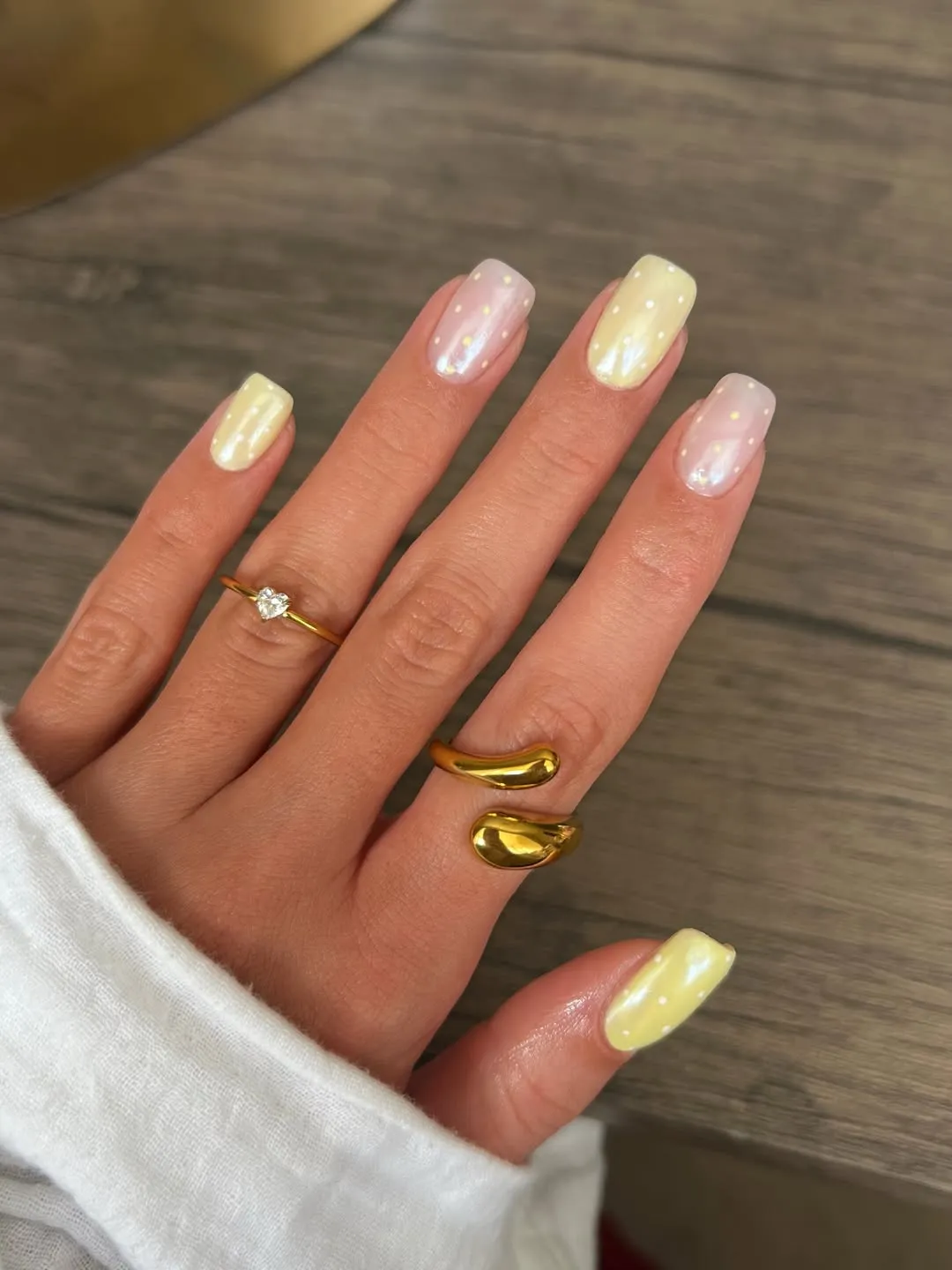 Soft pastel nails with subtle white dots