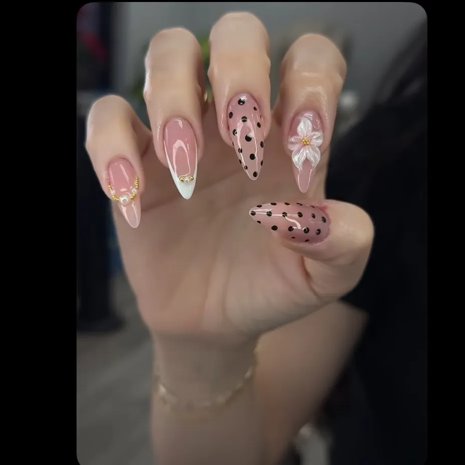 Nude Nails with Black Polka Dots and Floral Accent