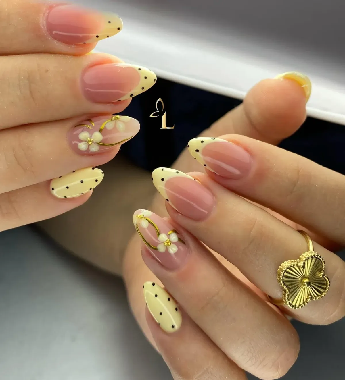 Yellow dotted French tips with floral accents