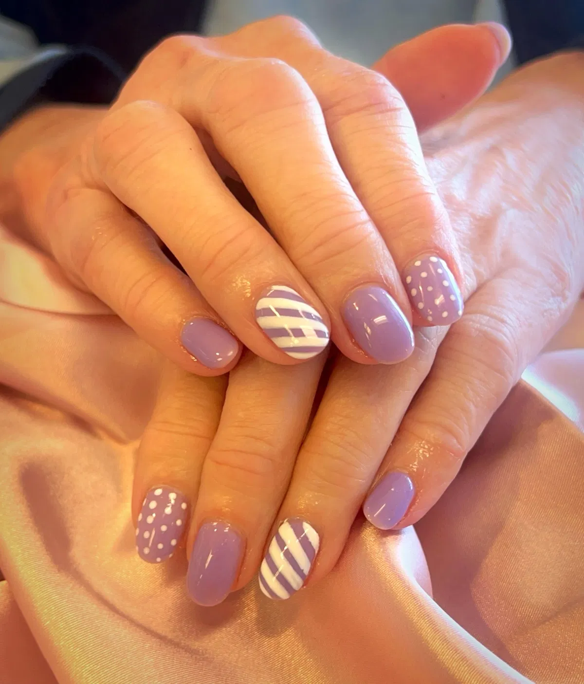 Lavender short nails with striped and polka-dot accents