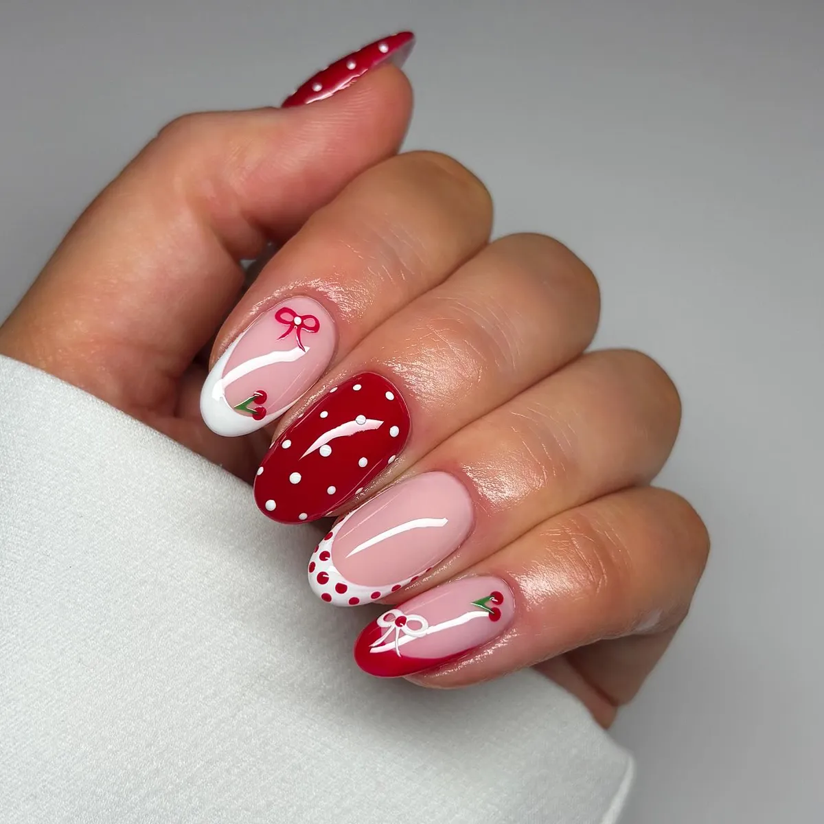 Cherry and bow accents with red polka-dot feature nail