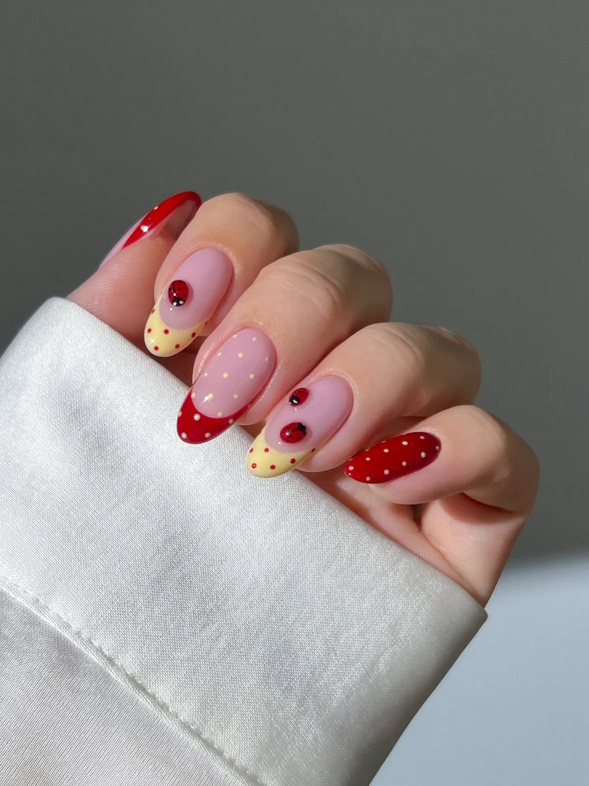 Ladybug accents with red polka dots and pale yellow dotted tips