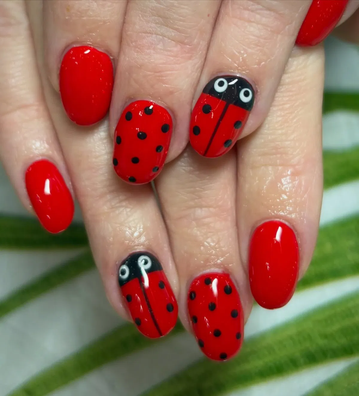 Red-and-black polka dots with ladybug character nails