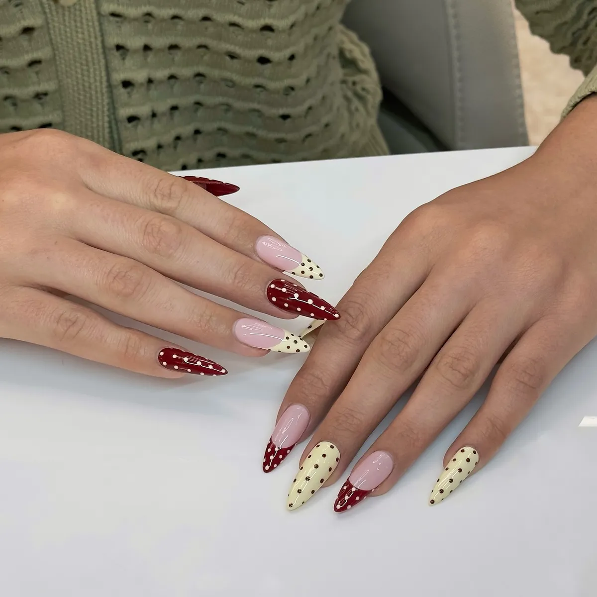 Stiletto mix: red polka dots, cream dotted nails, and pale pink solids