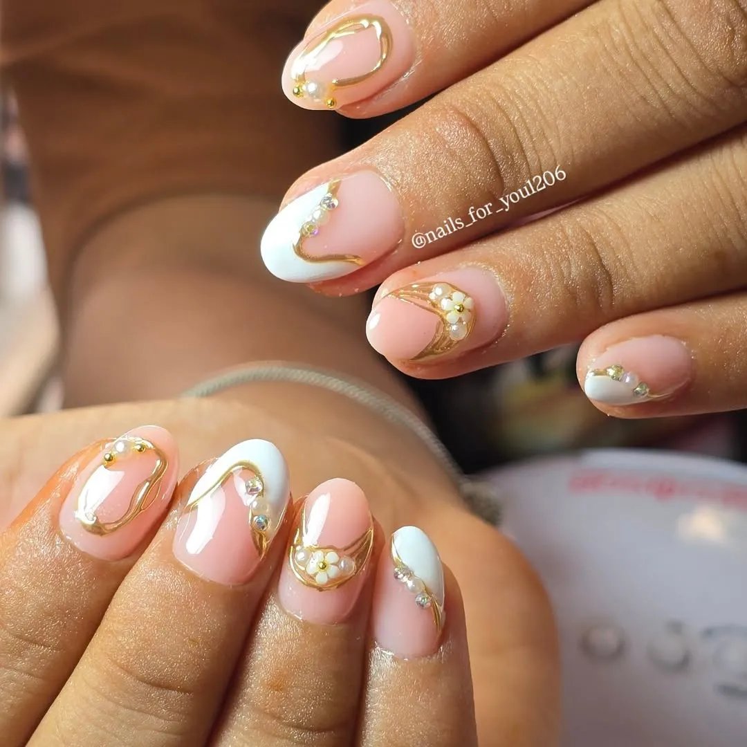 Curved white tips with gold linework and tiny florals