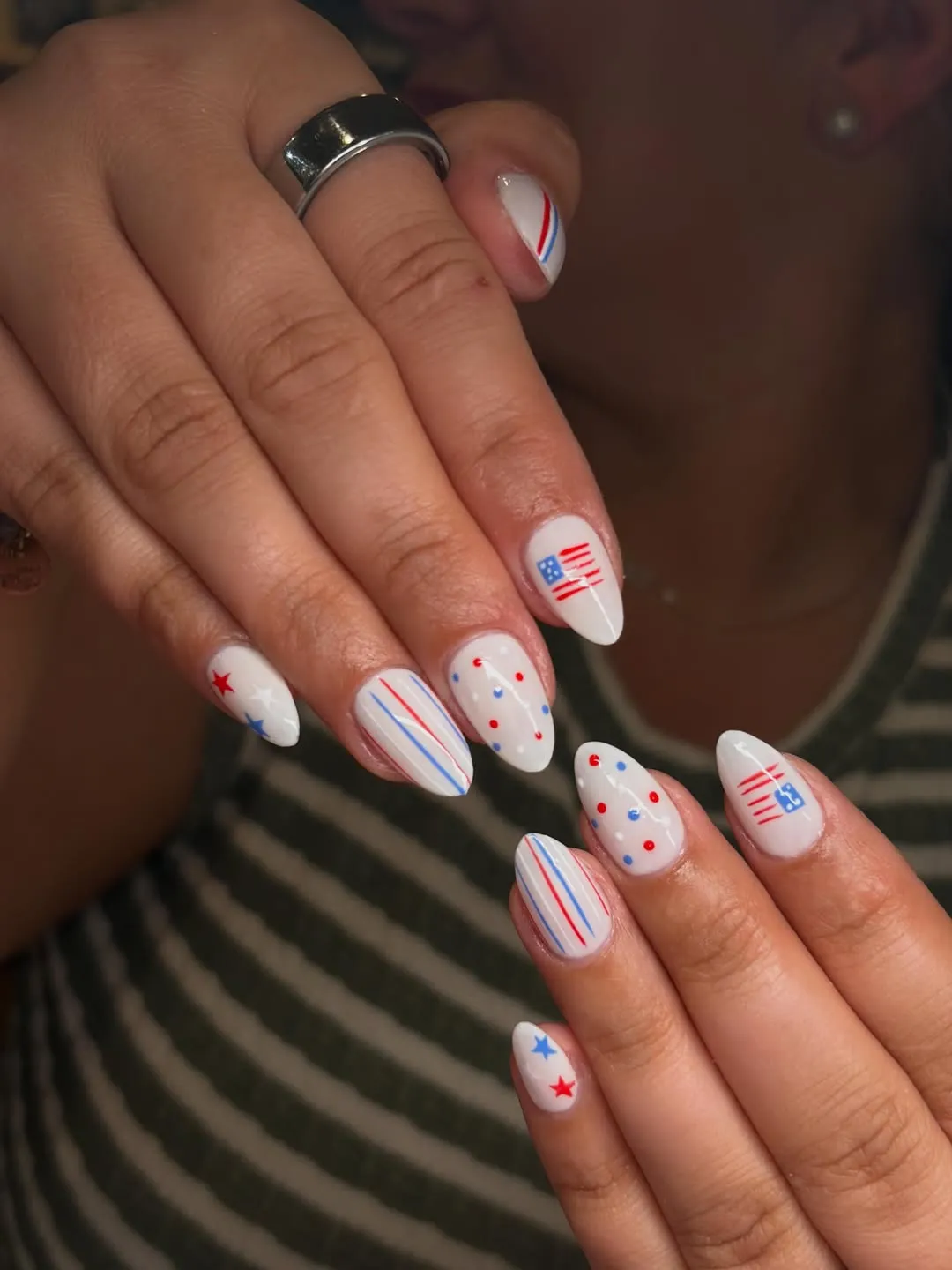 White almond nails with stripes, dots, and small flag-like accents