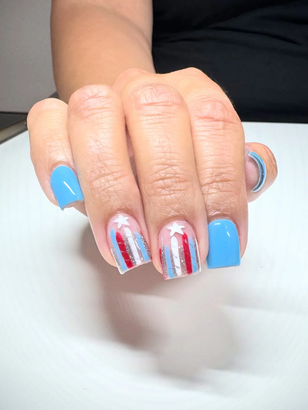 Light blue nails with striped star accent nails