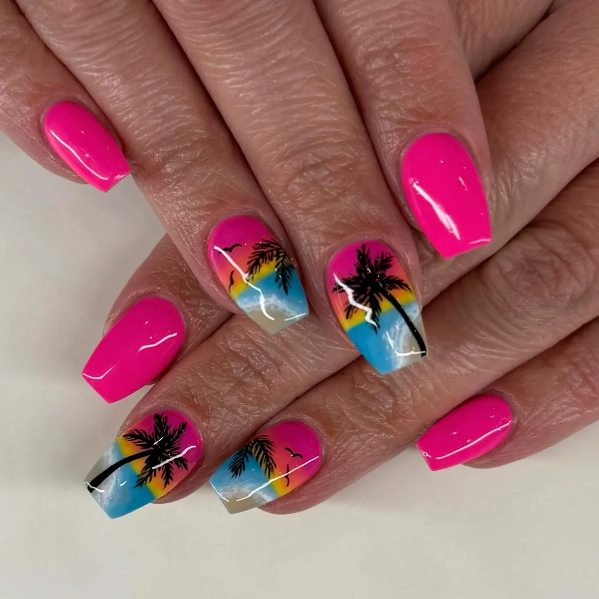 Hot pink nails with palm silhouette gradients