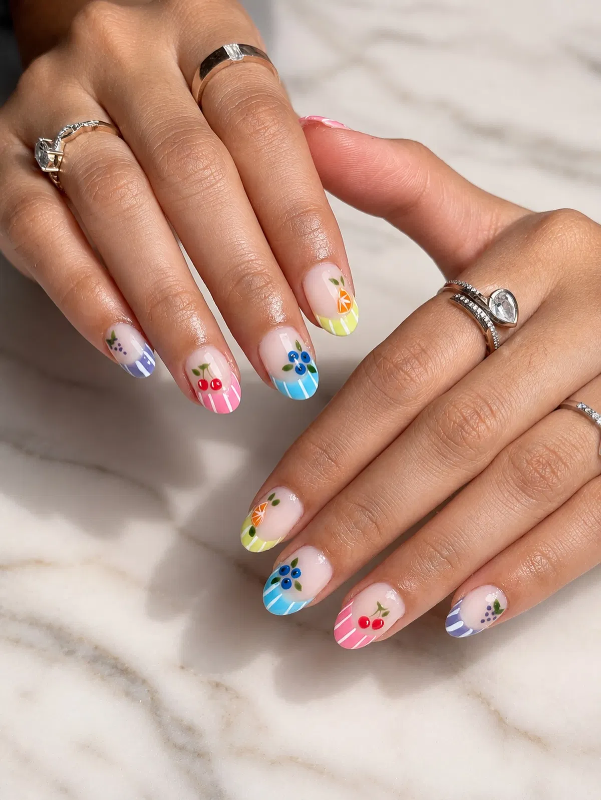 Pastel French tips with tiny fruit motifs