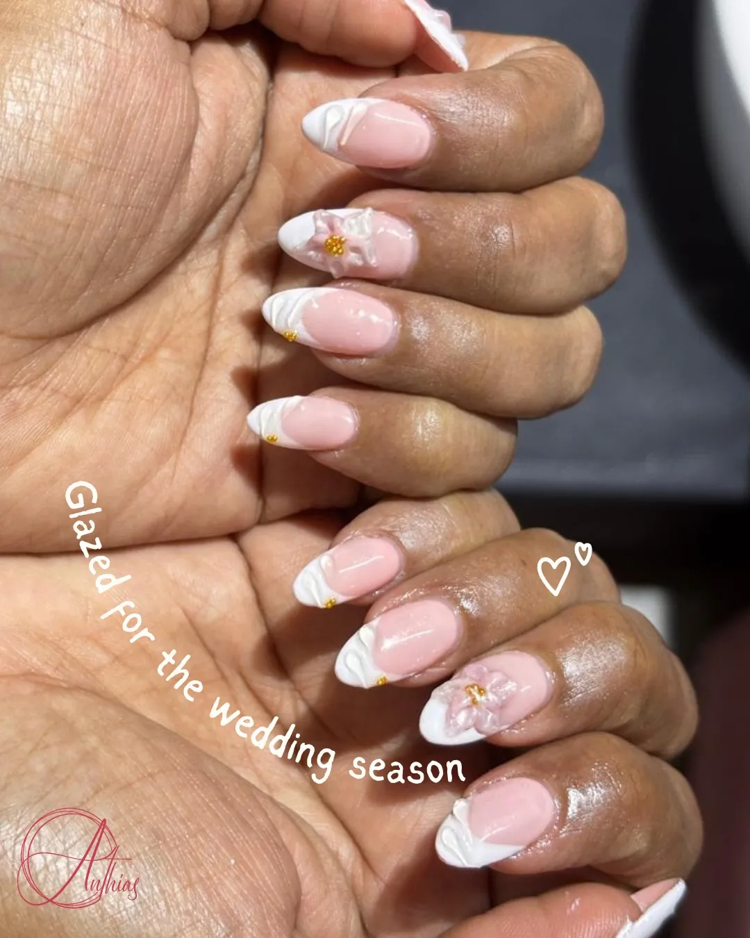 Pink almond nails with white curved tips and 3D floral accent