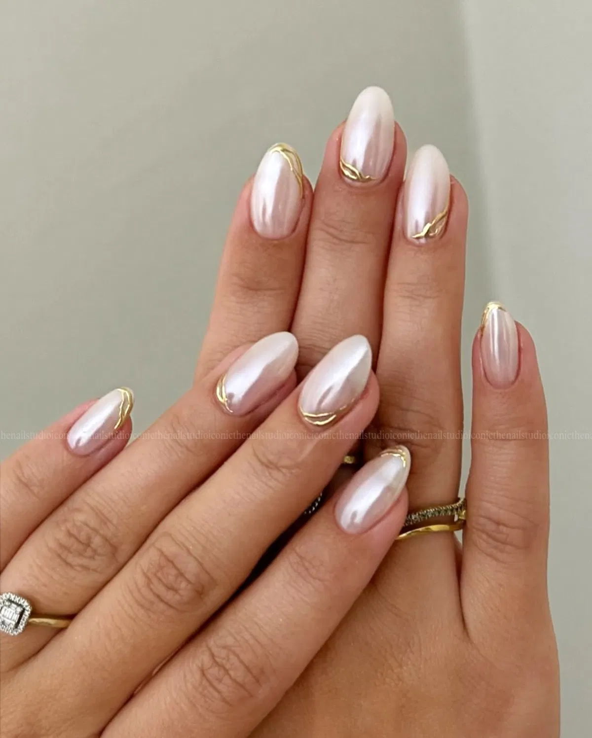 Pearly almond glow with thin gold cuticle curves