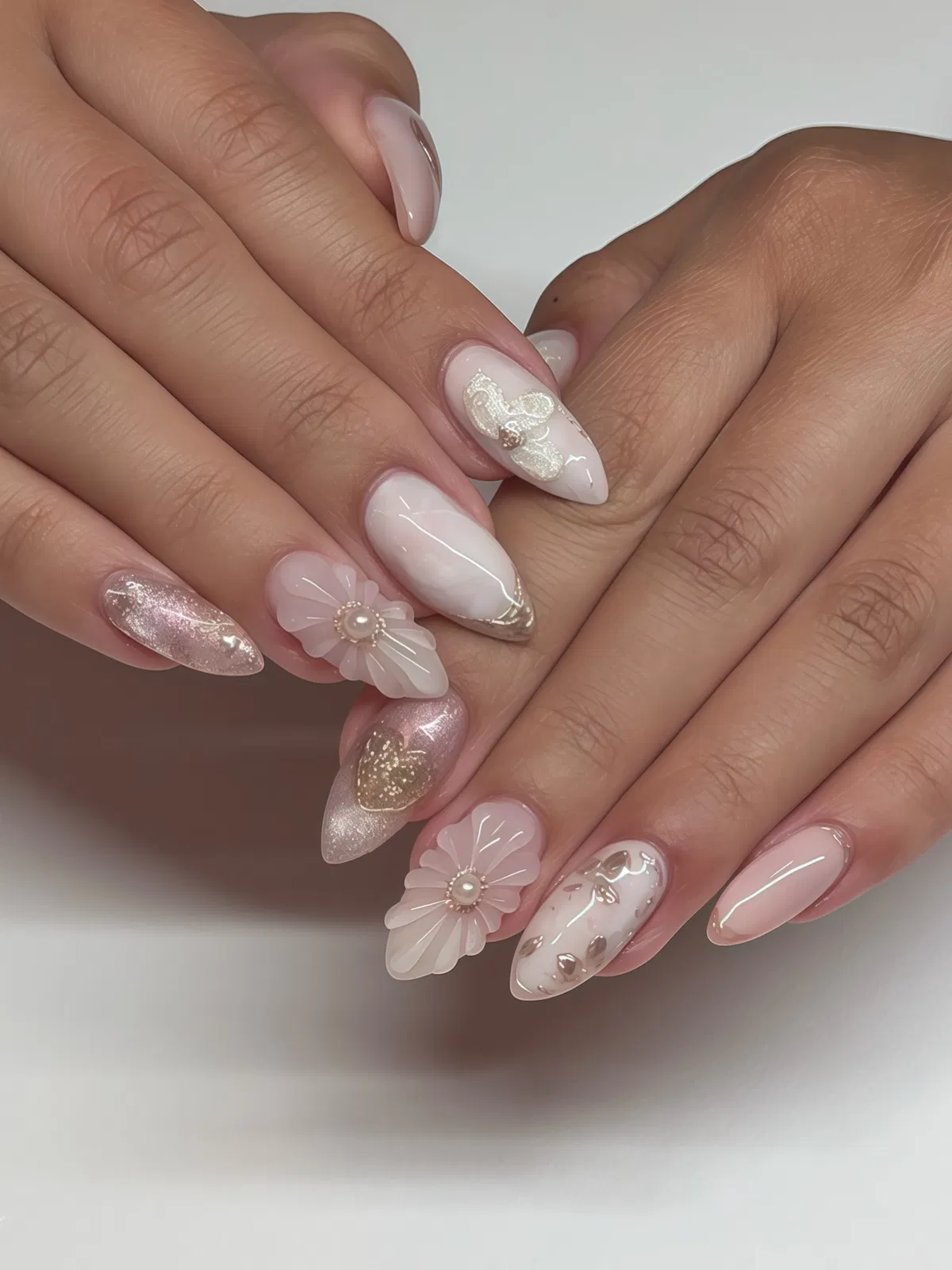 Mixed nude, milky white, and silver-glitter nails with 3D flowers