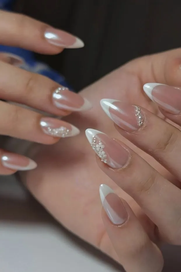 Classic white French tips with subtle gems
