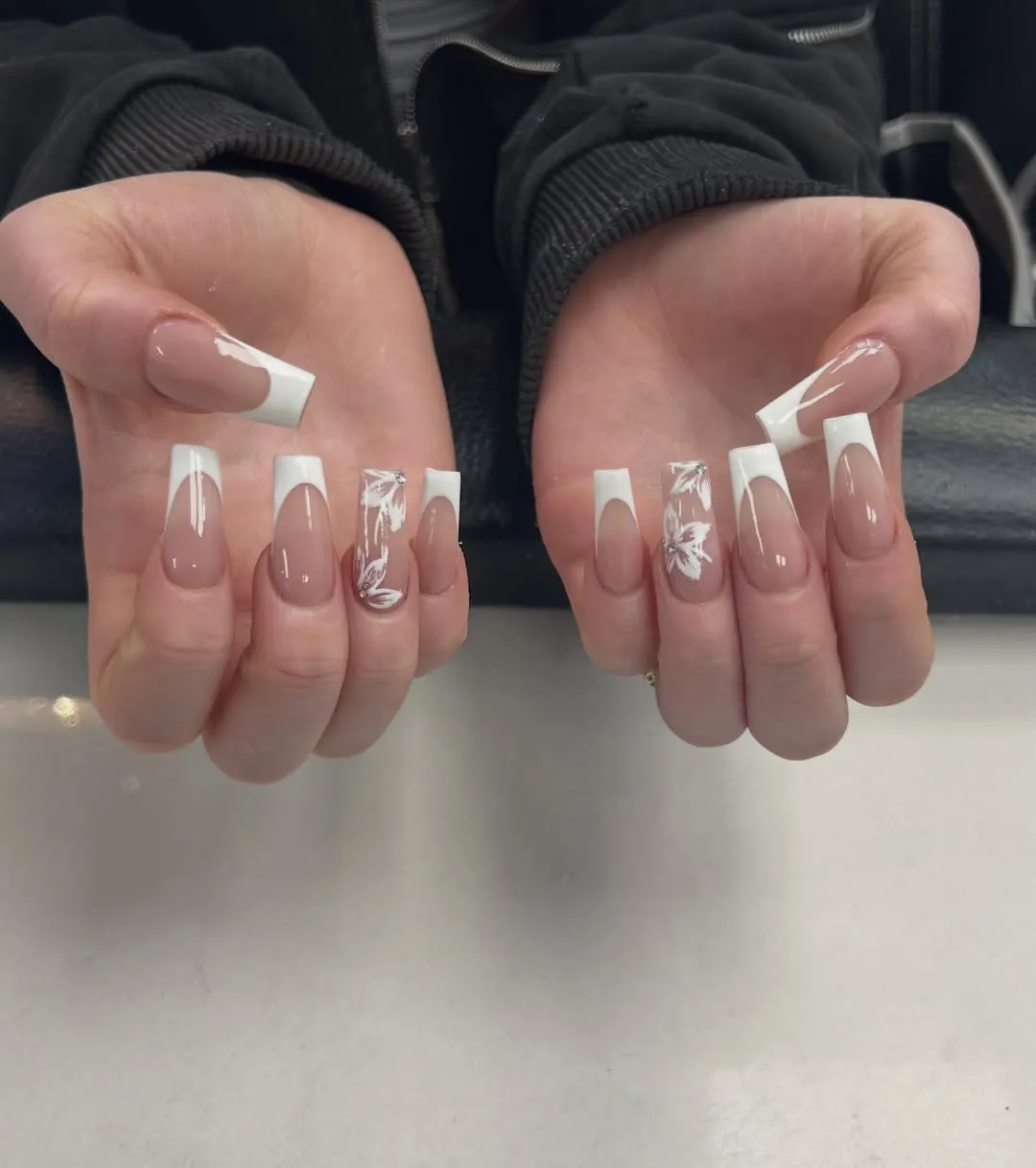 Deep-curve French tips with white floral line art