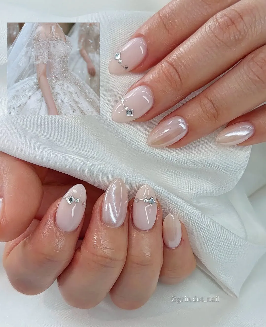 Pearly nude nails with small rhinestone clusters