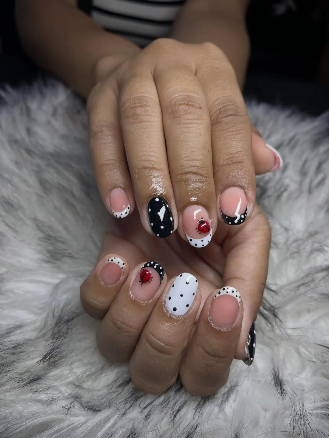 Short polka dot French tips with red ladybug accents