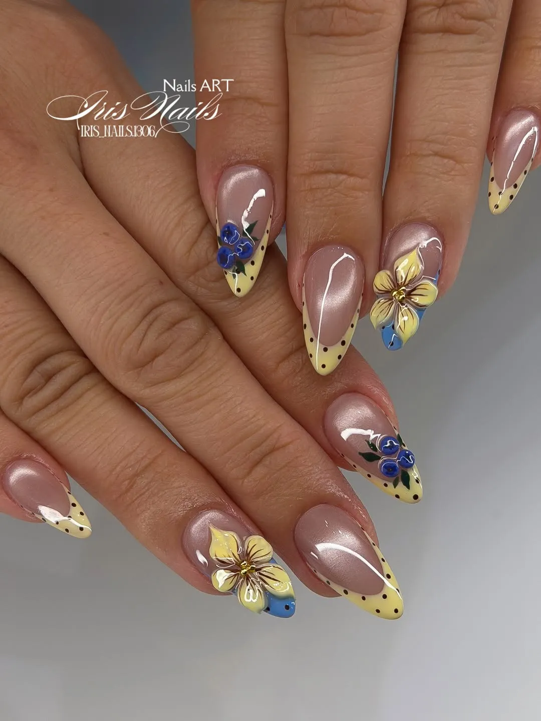 Almond nude base with yellow dotted tips and 3D flowers