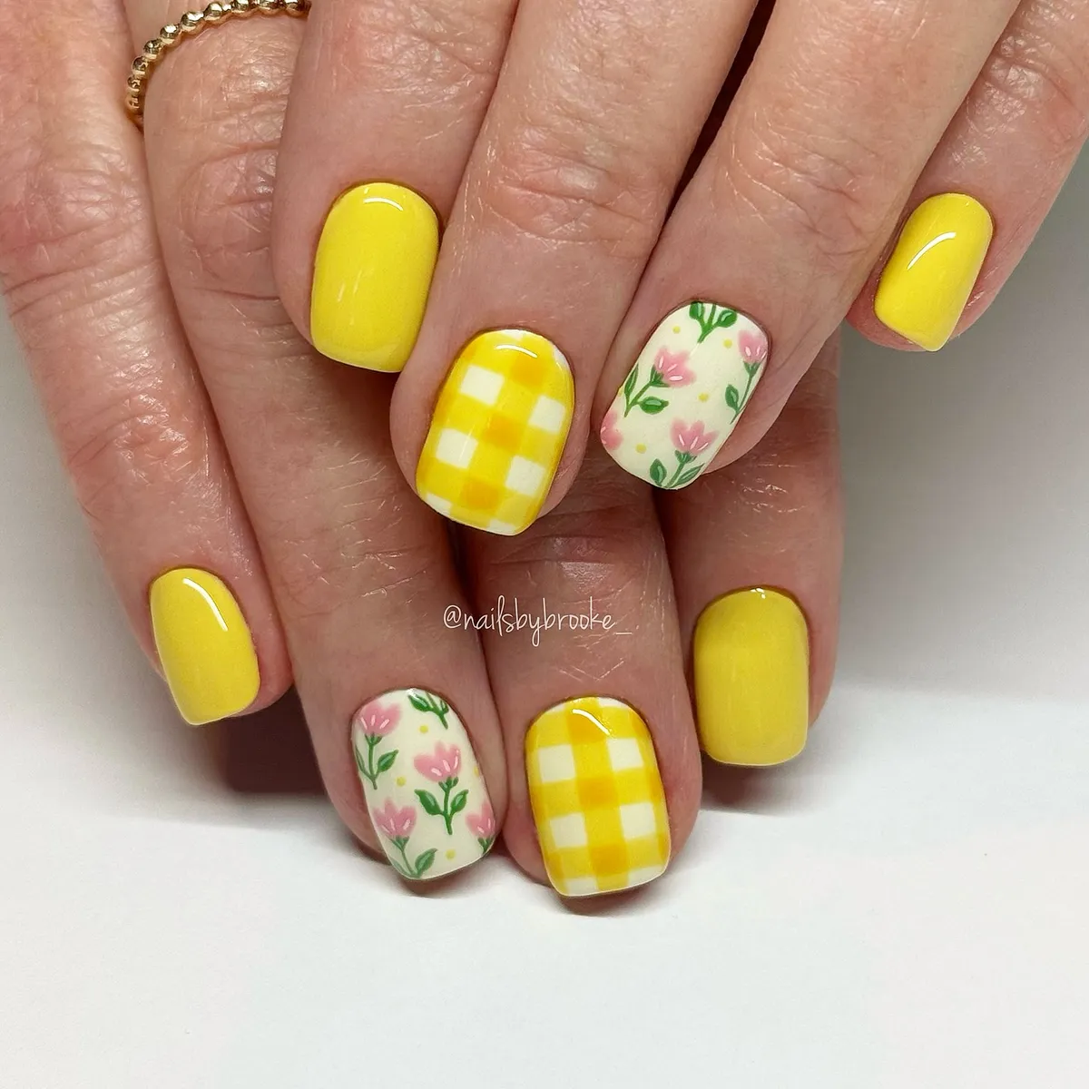Yellow solids with checkered accents and floral nails