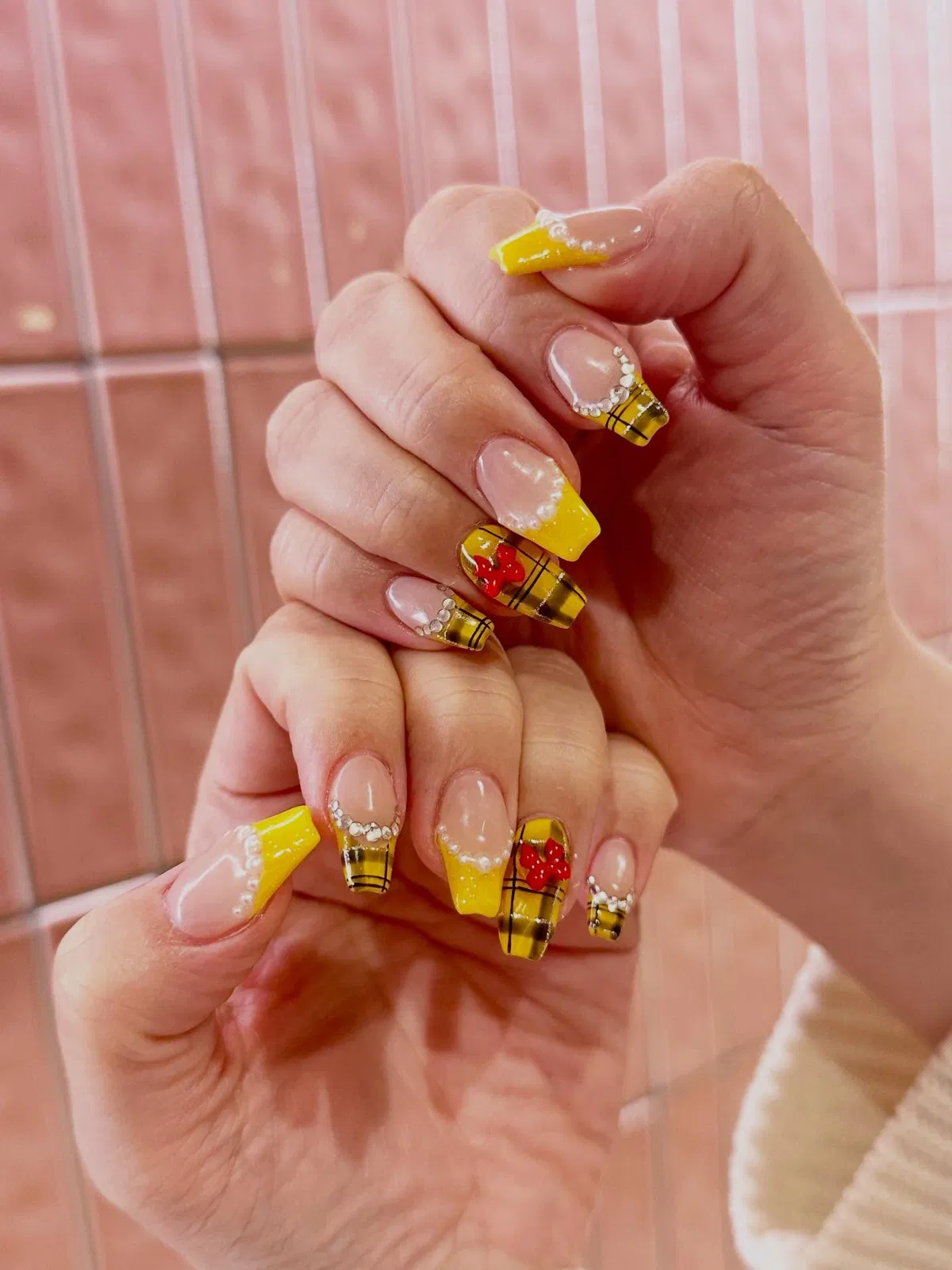 Yellow plaid French tips with rhinestone arcs and red floral accents