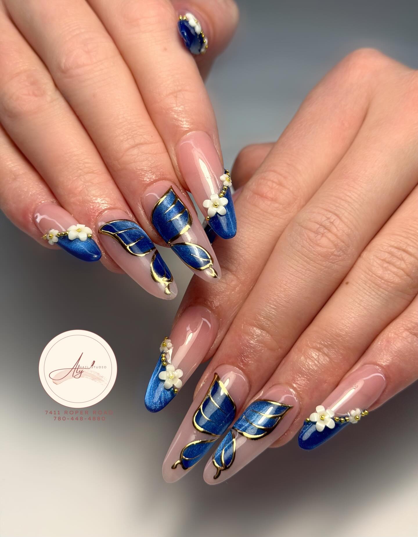 Metallic blue segments with gold lines and white flower accents
