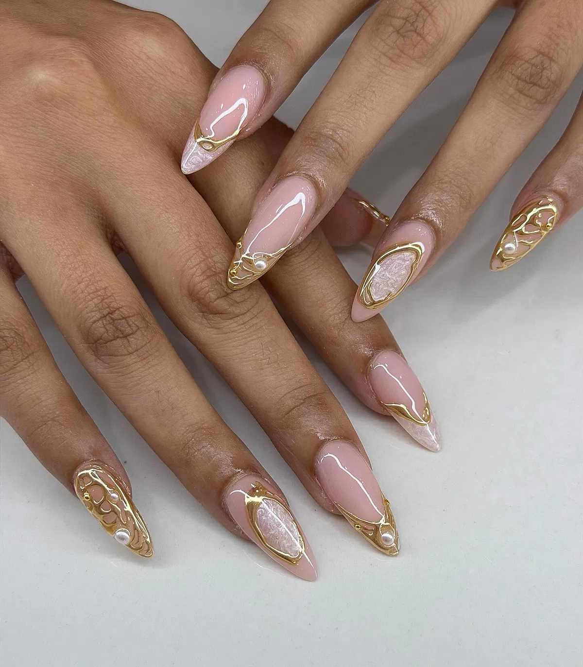 Pale pink set with raised gold contour lines