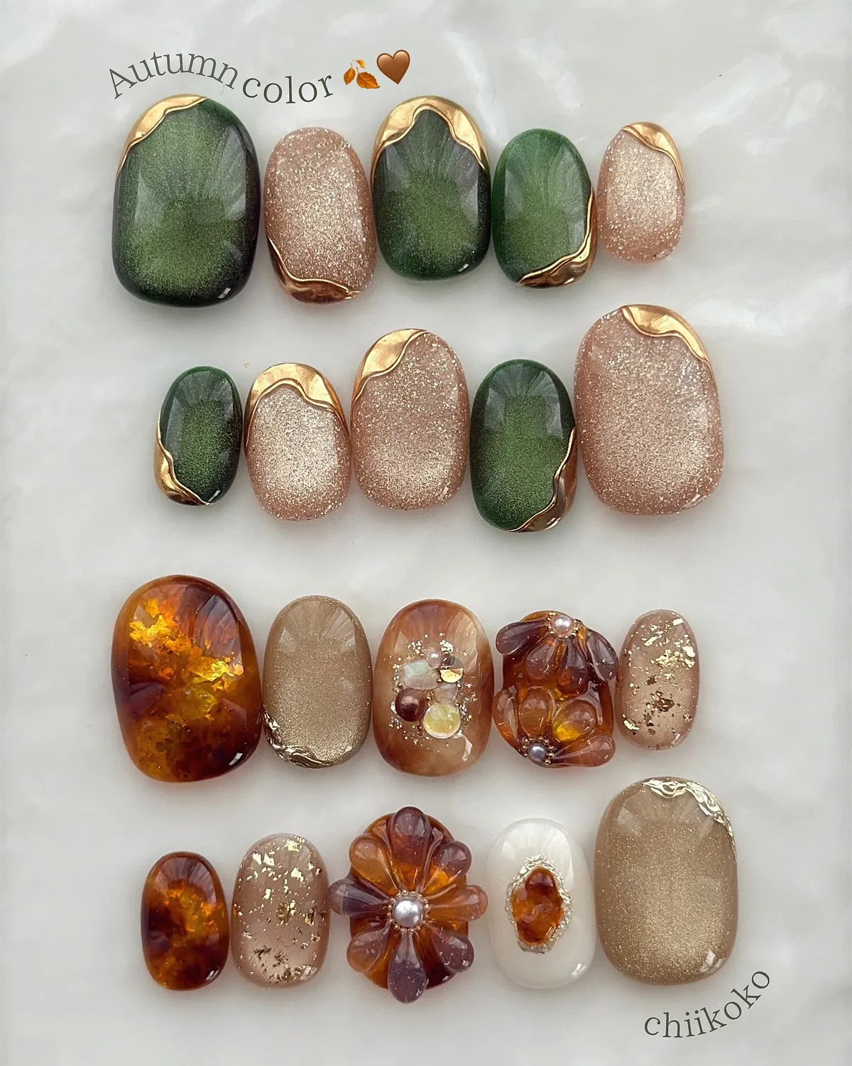 Green-and-glitter tips plus amber marbles and large 3D floral pieces