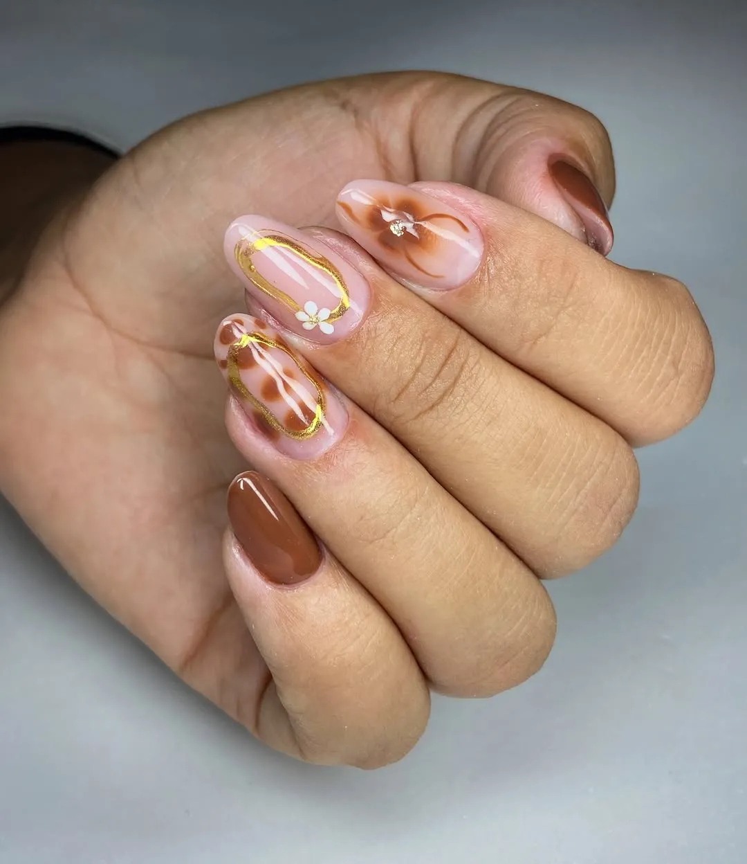 Nude marbled swirls with thin gold outline and tiny flower detail