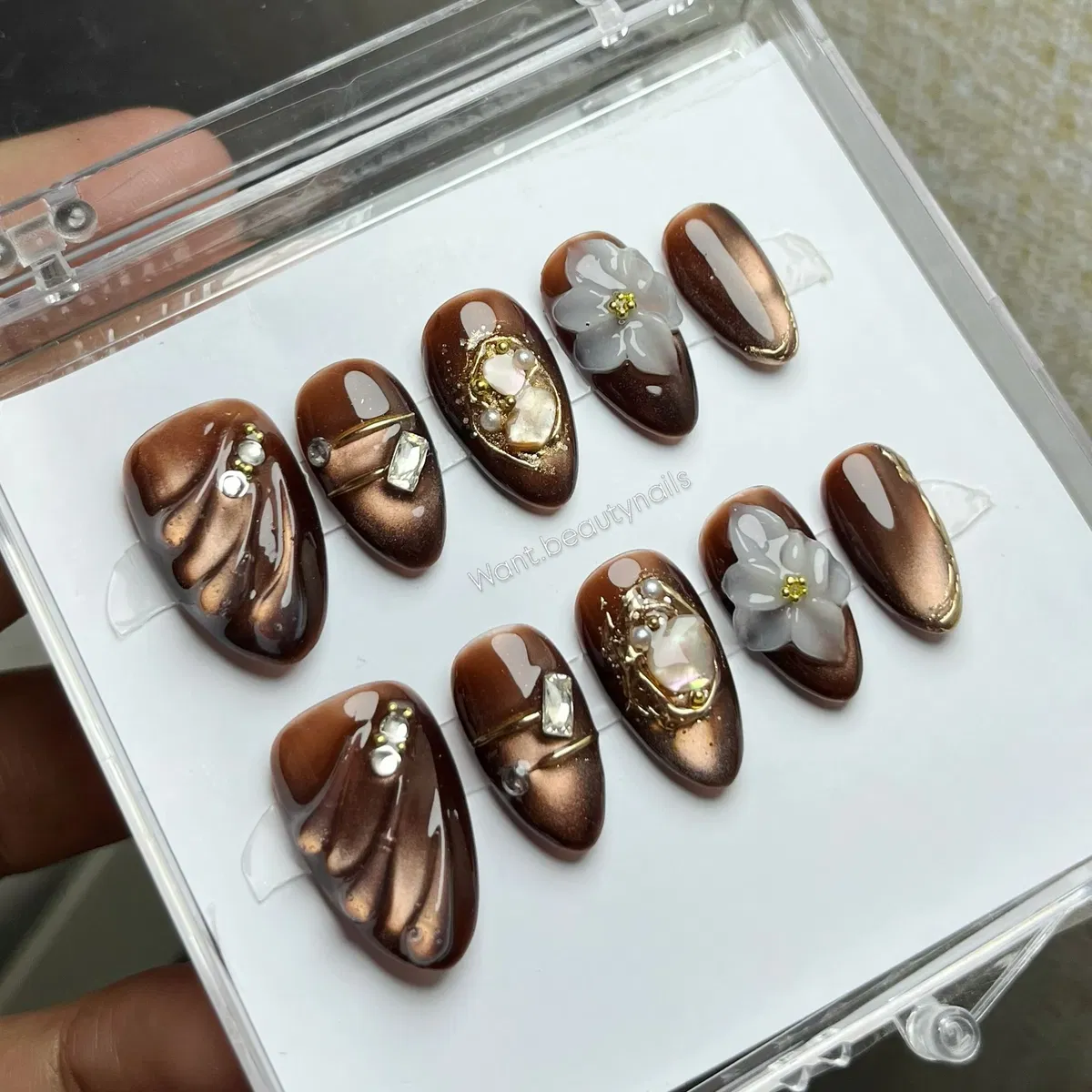 Bronze-brown embellished tips with gems and translucent 3D flowers