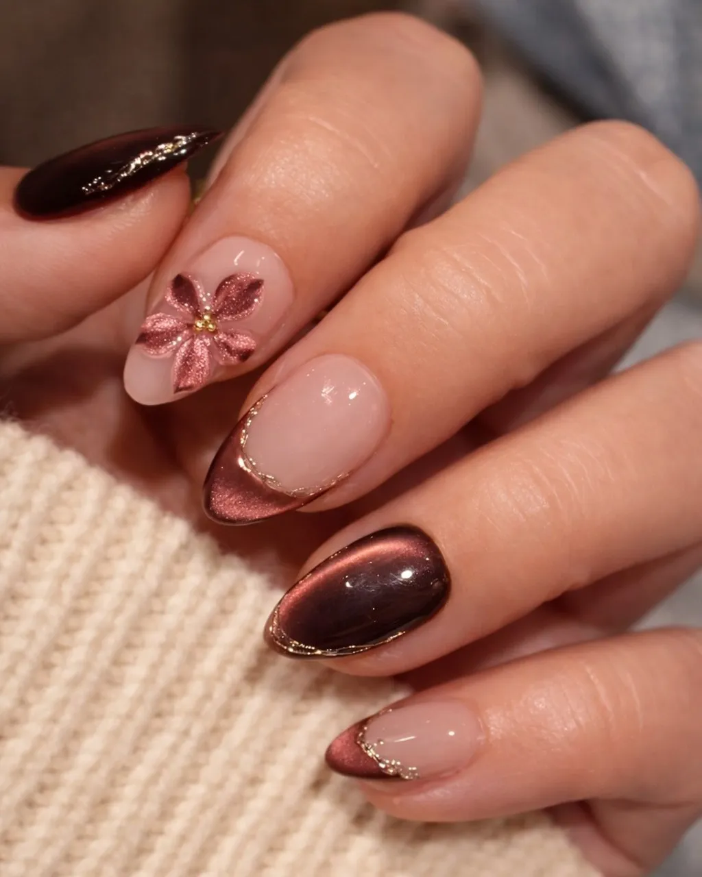 Metallic rose-brown French tips with floral accent