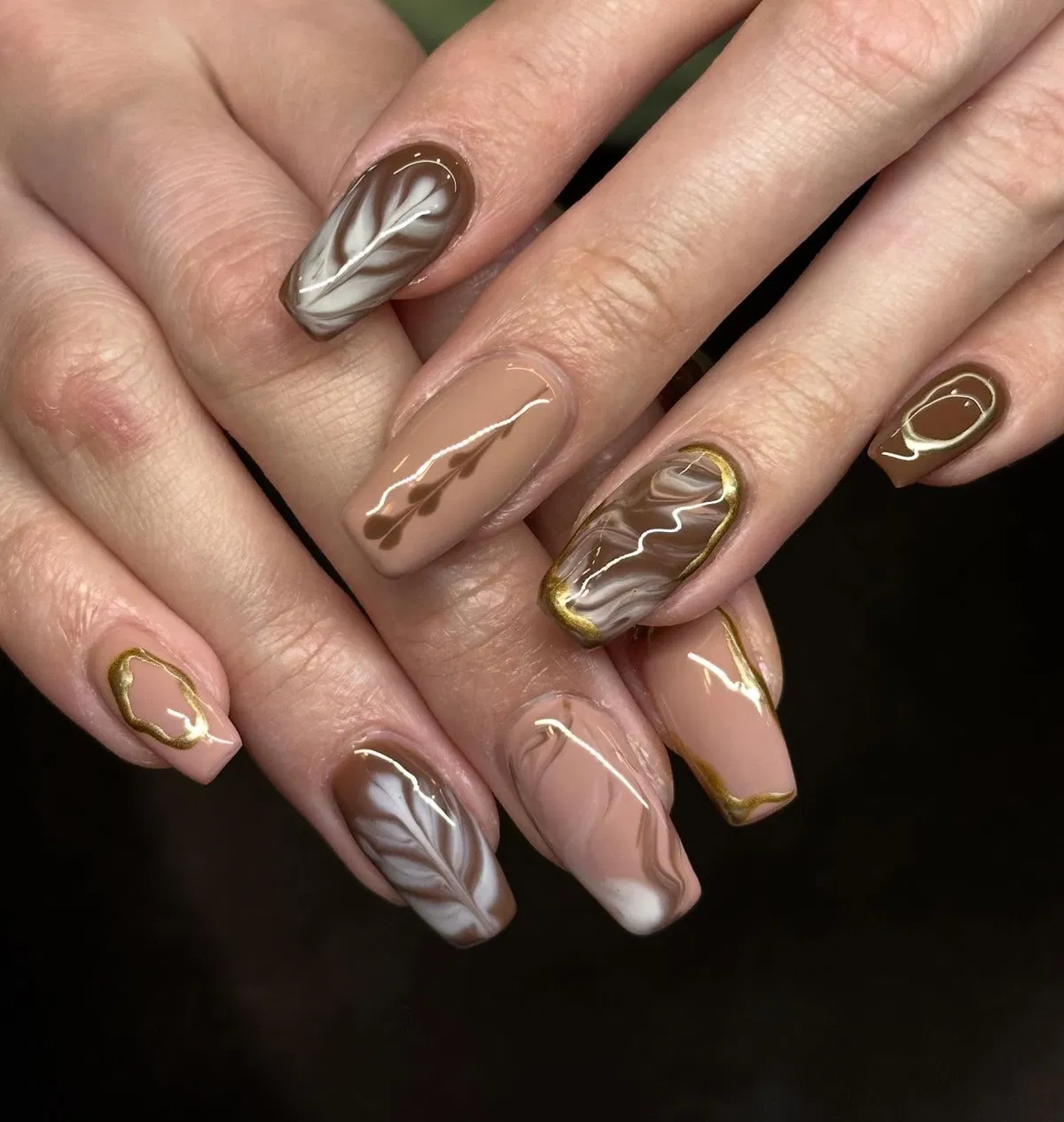 Brown-and-white marbling with gold outline accents
