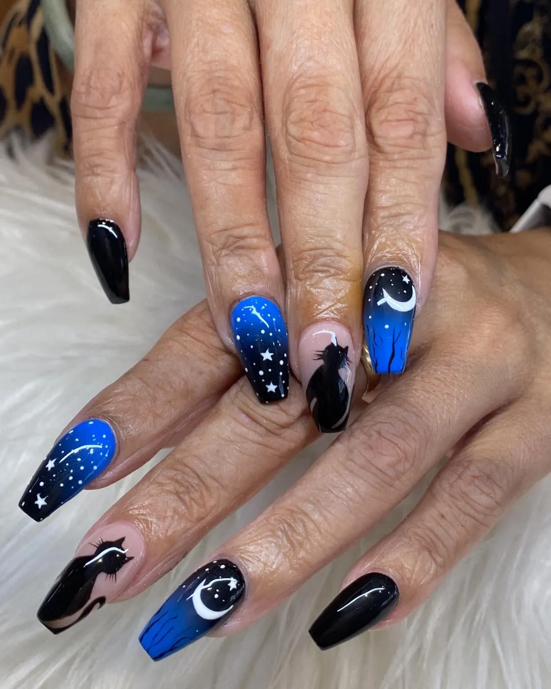 Blue-black gradient with moons, stars, and cat silhouettes