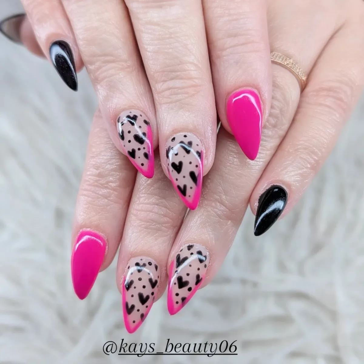 Hot pink tips with black hearts on nude base