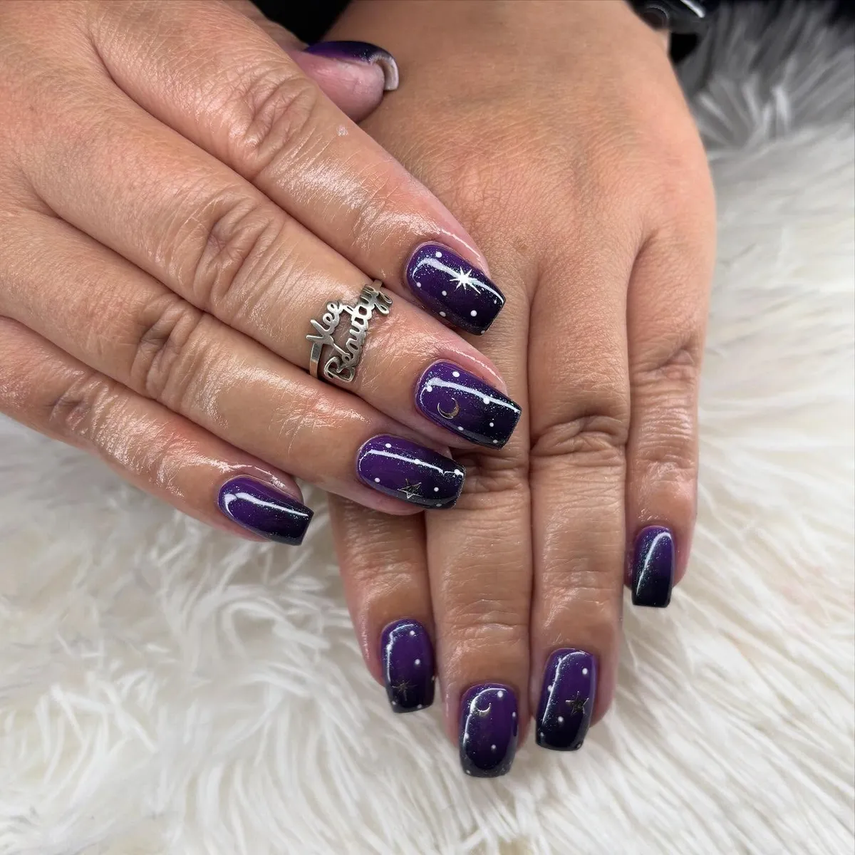 Purple-black galaxy gradient with stars and moons