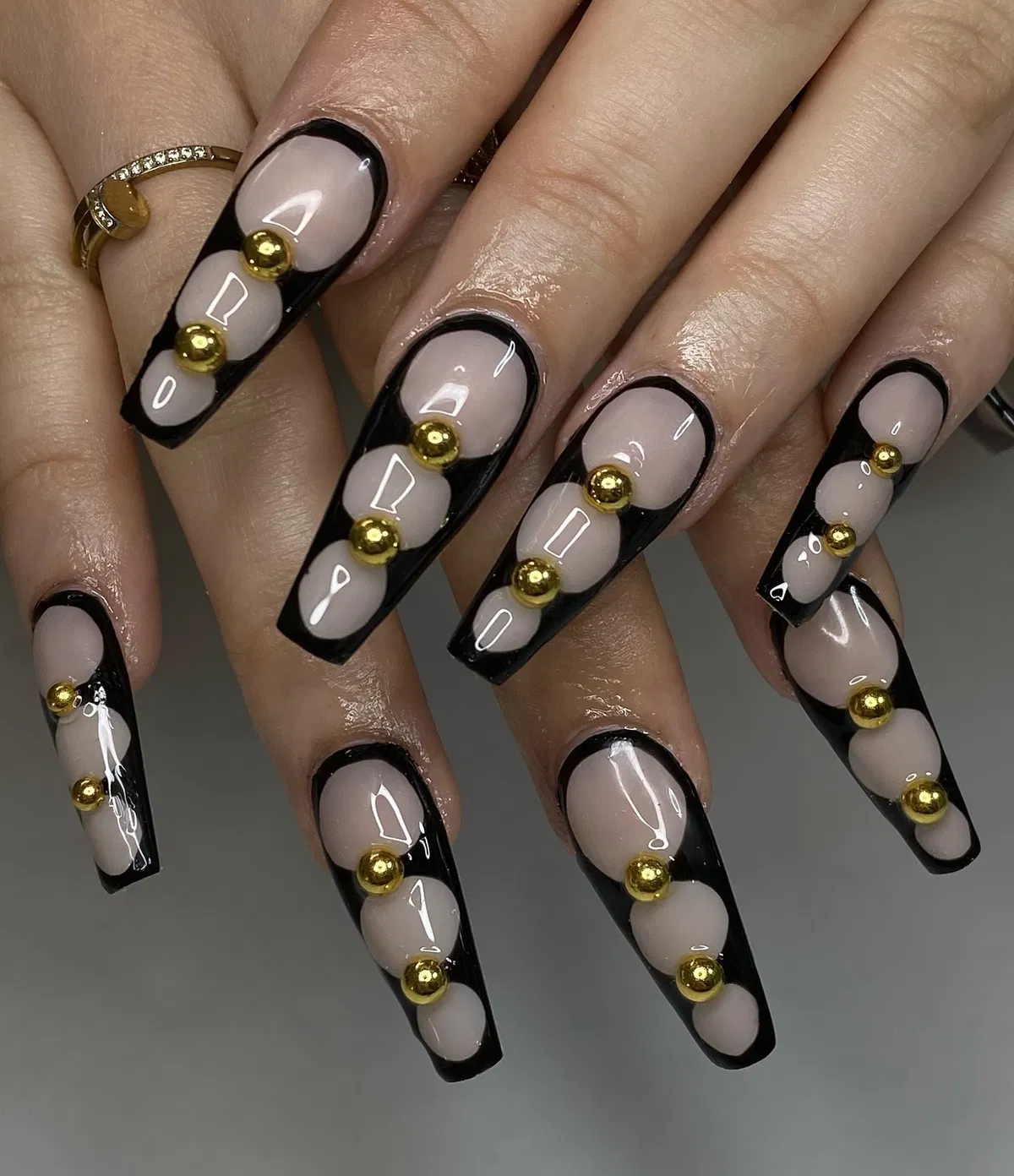 Black-framed nude ovals with gold bead accents