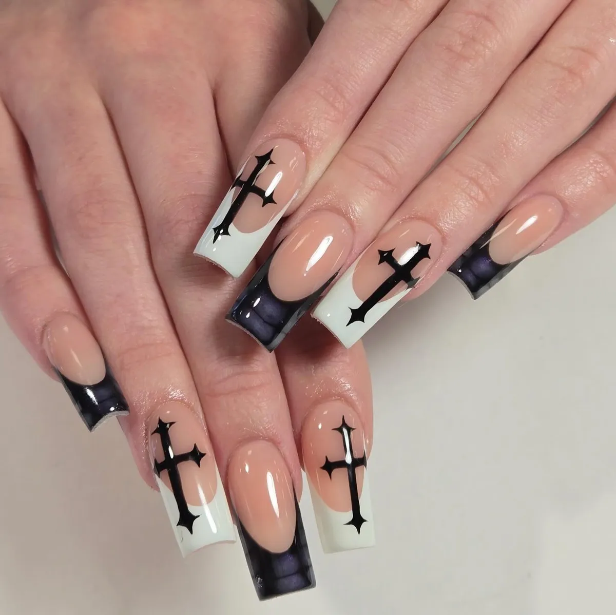 Nude-and-white tips with black cross motifs