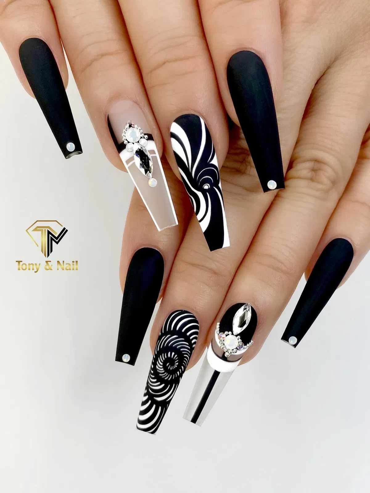 Matte black set with black-and-white swirl accents and gems