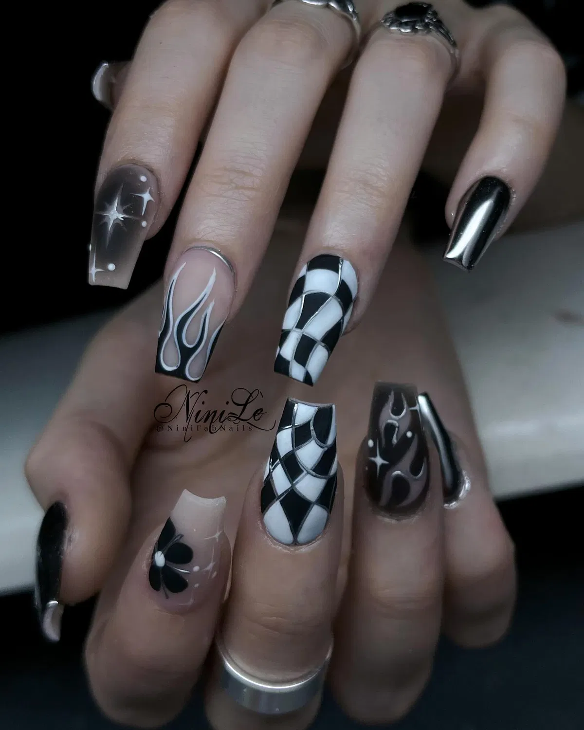 Mixed black designs: checkerboard, flames, and star motifs
