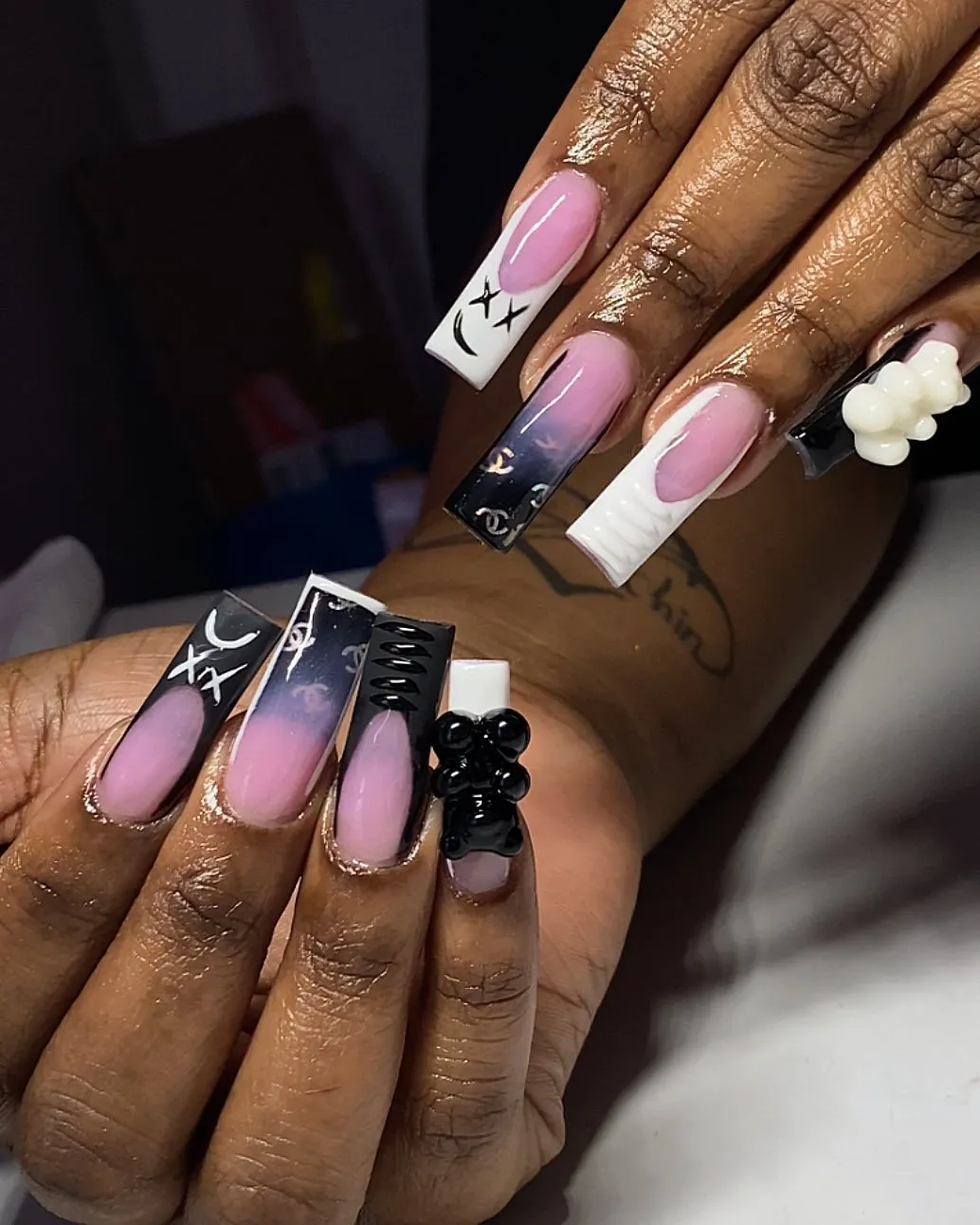 Short glossy black nails with small white flower accents