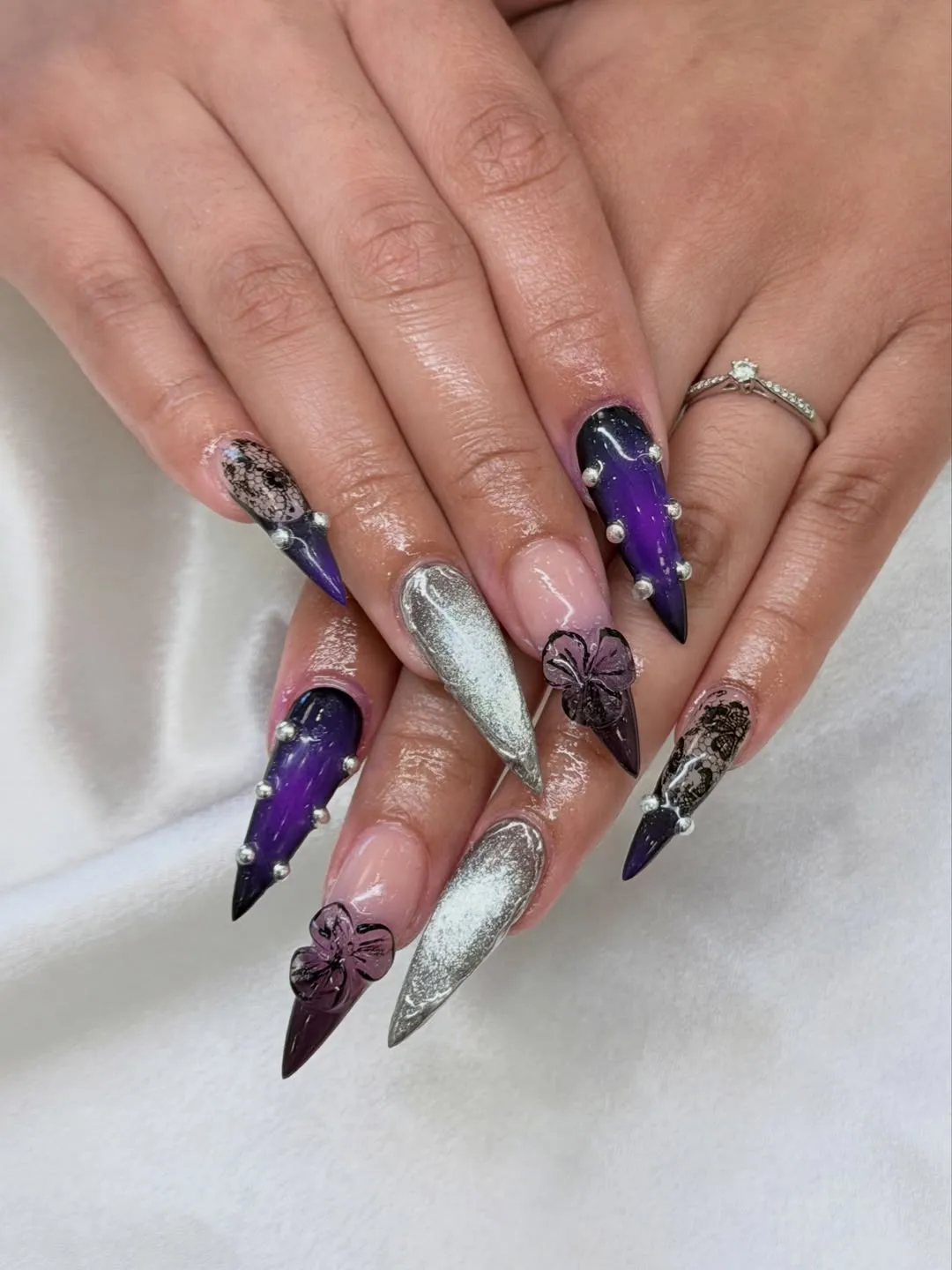 Purple-black stiletto set with studs and floral accents